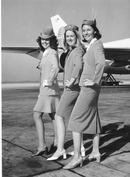 September 1971:  Pan American Airways stewardesses displaying the airline's uniform through the decades at London Airport.